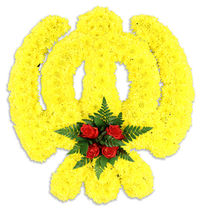 Framed against an immaculate white background, this large floral Khanda is composed almost entirely of bright yellow chrysanthemum heads, each bloom placed so tightly that they read as a continuous, luminous surface. The emblem's defining elements-the encircling chakram, the central double-edged khanda sword and the two crossed kirpans-are clearly articulated by the uninterrupted sweep of yellow, the petals creating subtle shadows and a gentle three-dimensional relief. Anchoring the centre is a deliberate, solemn cluster of deep red roses-five closely gathered buds surrounded by lush, dark green fern fronds-which provides a dramatic counterpoint in both hue and texture. The deep crimson of the roses draws the eye inward, the ferns acting as a natural frame that separates the focal point from the expansive yellow field. The white backdrop and a soft grey shadow under the composition indicate a standalone tribute: a wreath or ceremonial panel destined for a gurdwara service, community remembrance or funeral rite. Light is soft and even, revealing the chrysanthemums' ruffled surfaces and the roses' velvety cups without glare, while the overall impression is one of dignity, warmth and careful technique. This arrangement would sit comfortably in places across South Croydon and nearby community halls-visible and respectful whether delivered for a service near Croydon High Street or set within a memorial at a local community centre-offering a considered floral expression of faith, respect and cultural remembrance.